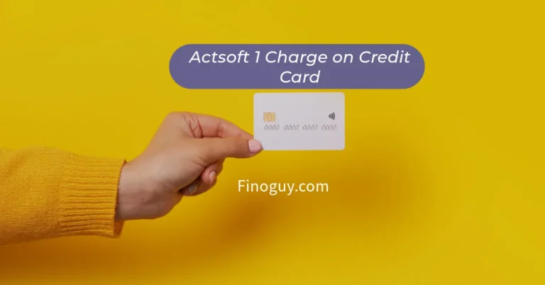 A close-up of a woman's hand holding a credit card in front of a solid yellow background. Text on the card reads "Actsoft 1 Charge" and "Finoguy.com